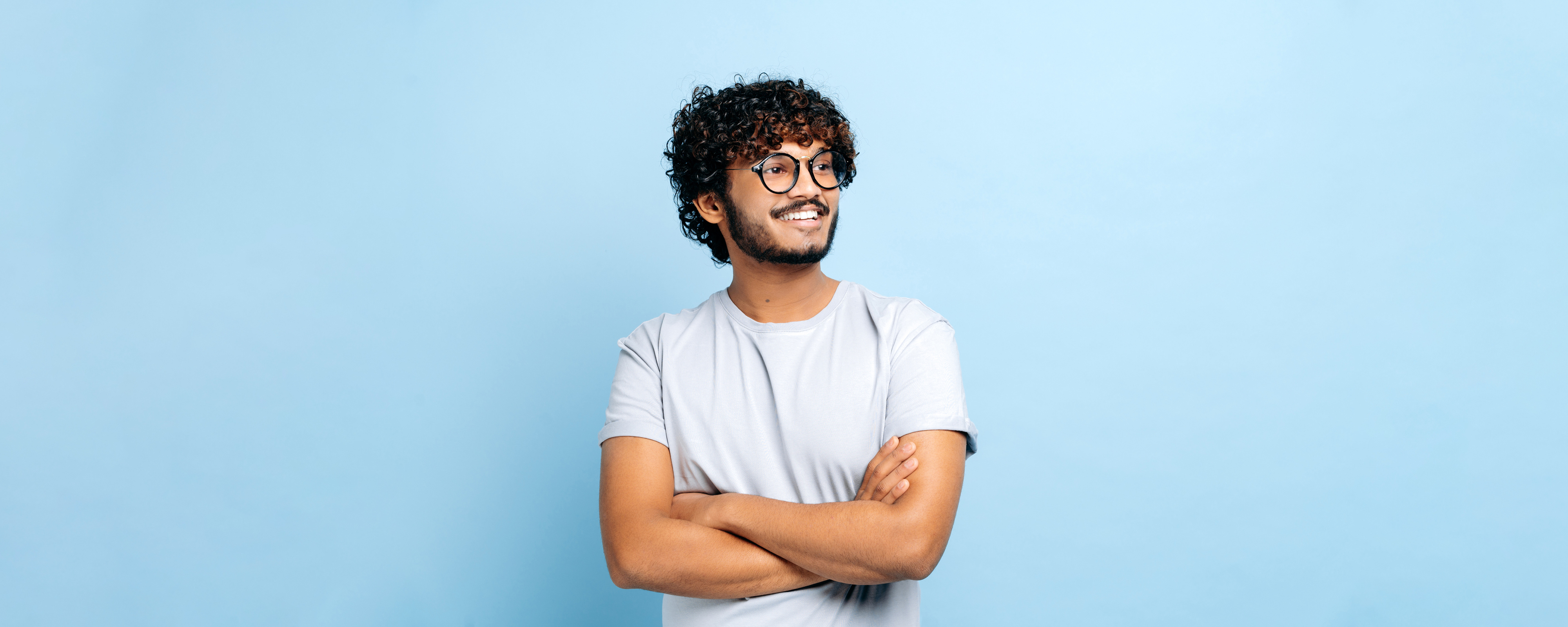 Image of a person wearing a light t-shirt and glasses looking to their left